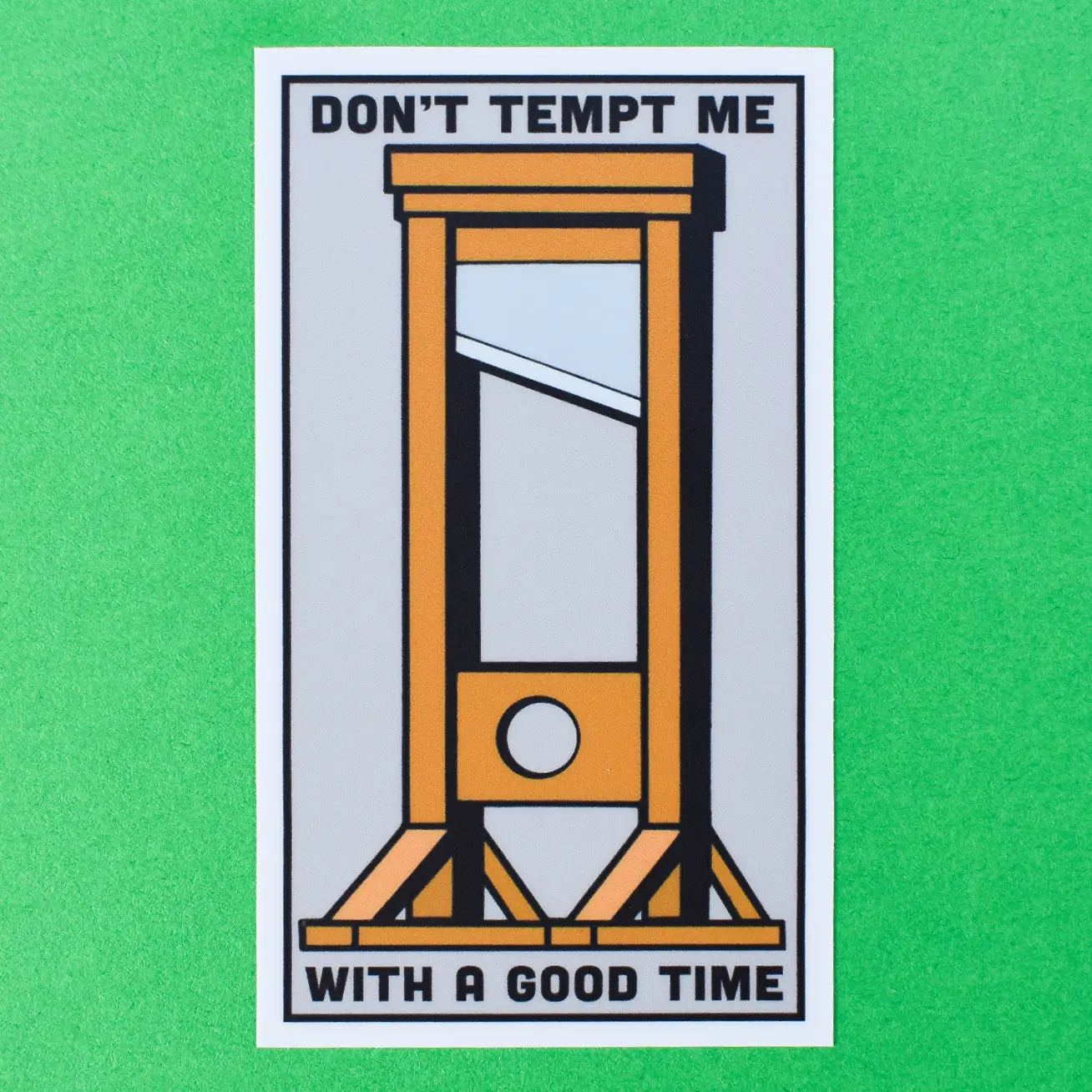 Rectangular vinyl sticker with an image of a brown wooden guillotine with the message “DON’T TEMPT ME WITH A GOOD TIME” on a light grey background