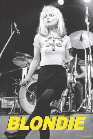 black and white photo of Blondie frontwoman, Debbie Harry, in action onstage in Manchester, England in 1977 wearing Camp Fun Time t-shirt with “BLONDIE” written in bright yellow capital font