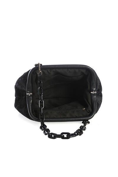 Black velvet purse with embossed damask pattern of chandeliers, candles, crescent moons, and roses. Has a black plastic chain link shoulder strap and faux leather hinge detail on the exterior. Shown from the top open