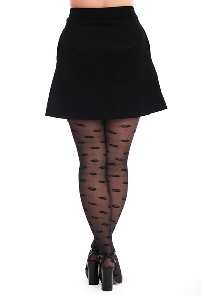 black corduroy button-front full a-line skirt in a above the knee length with side seam pockets. Shown on a model wearing patterned tights from the back