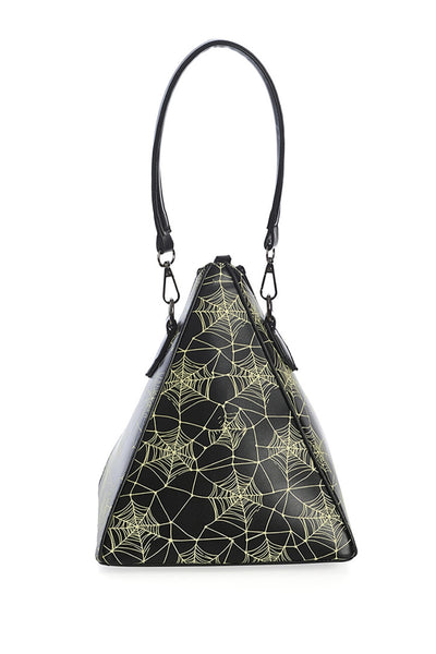 Pyramid shaped purse with all over glow in the dark cobweb printed pattern. It has a matching black faux leather shoulder strap and there are two vertical black zippers running down the side of the pyramid. Shown from the side