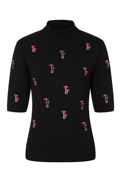 Black elbow length sleeved turtleneck sweater with ribbed neck and cuffs. Embroidered toadstool mushrooms in red, white, and brown across the front body and sleeves of the sweater. Shown from front