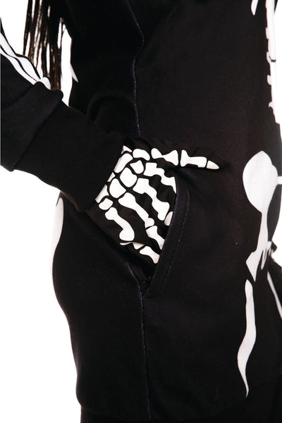 A model wearing a black fleece long sleeved zip up dress with a hood. It has a white anatomical skeleton motif. Shown from the side with hand in pocket