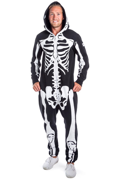 A male model wearing a black lightweight fleece zip-up jumpsuit with an all-over anatomical skeleton screen printed motif. The zipper runs to the top of the hood and it has two mesh covered eye holes. Seen from front zipped to the neck 