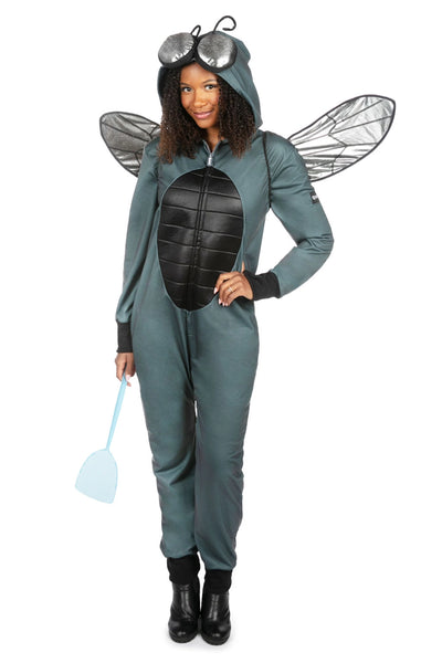 Female model wearing a polyester unisex fly costume jumpsuit. It is dark grey with a black thorax detail on the center of the stomach and has an oversized hood with silver lamé eyes and posable antennae. Shown with hood up, wearing posable silver lamé wings and holding blue plastic fly swatter. Shown from front