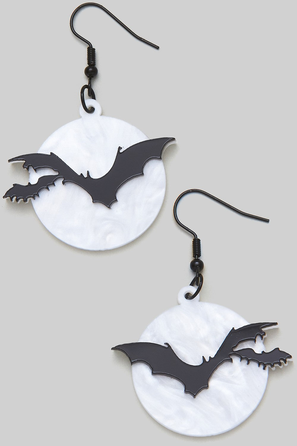 Acrylic black bats flying against a pearly white full moon dangle earrings