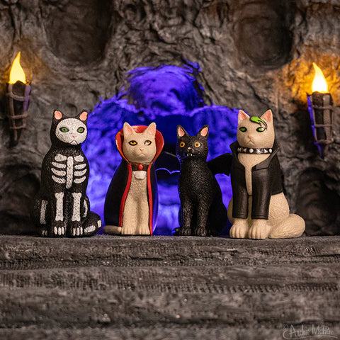 Set of 4 “Goth Cats” soft vinyl figurines in front of a dark background 