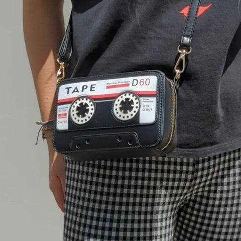 Novelty purse in the shape of a black cassette tape with crossbody strap