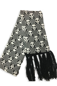 knit scarf with a black and white checker-on-checker pattern with little white skulls finished with a black fringe at each end