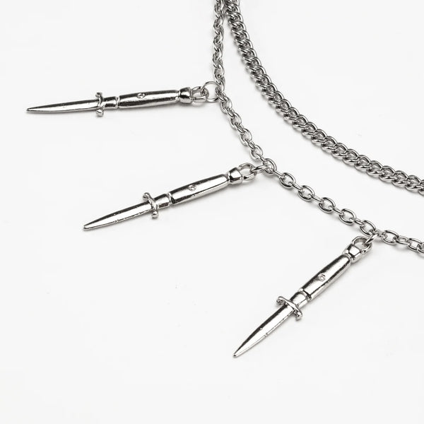 Silver metal box and link double chain necklace with 6 vertically hanging switchblade pendants on the box chain. Shown flat in close up of pendants 