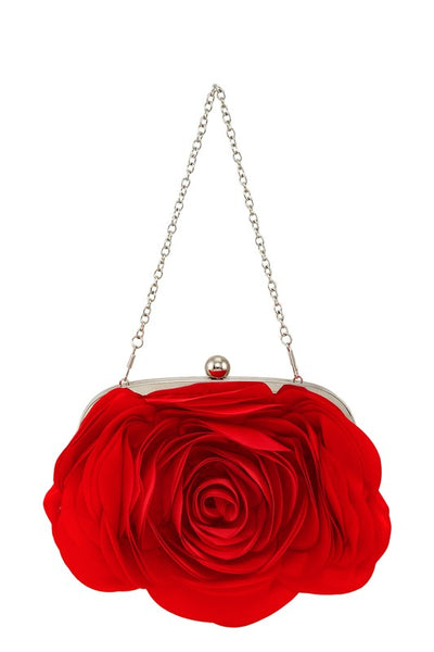 Purse made of a shiny satiny bright red fabric with layers of petal shapes sewn onto the body of the bag to resemble a rose. Silver metal hardware with a kiss lock and silver metal link chain strap. Shown from the front