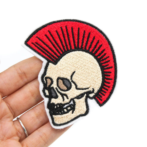 White felt embroidered patch of an off-white skeleton with a large red Mohawk 