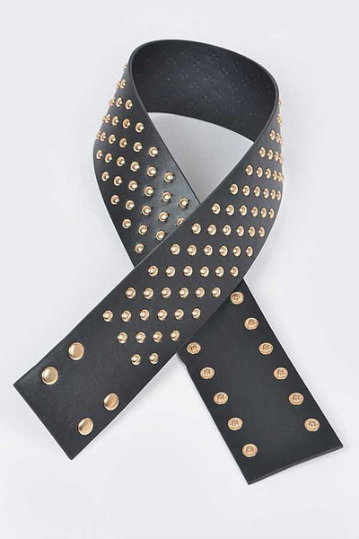 A black faux leather waist belt covered with gold metal round studs. Shown flat