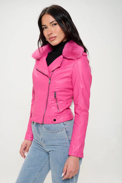 A model wearing a hot pink faux leather motorcycle style jacket with a matching hot pink faux fur collar. The jacket has silver metal zippers and hardware. Shown from the side zipped up