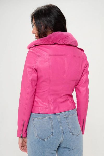 A model wearing a hot pink faux leather motorcycle style jacket with a matching hot pink faux fur collar. The jacket has silver metal zippers and hardware. Shown from the back