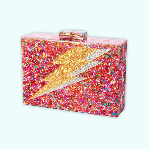 Rectangular hard resin clutch purse with chunky rainbow confetti inlaid. Large silver and gold glitter lightning bolt on front. Shown from the front