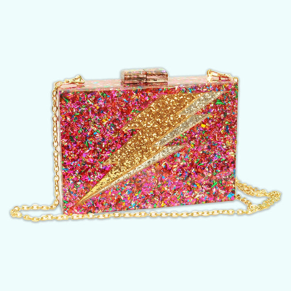 Rectangular hard resin clutch purse with chunky rainbow confetti inlaid. Large silver and gold glitter lightning bolt on front. Shown from the front with chain strap