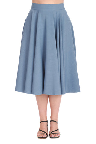 Model wearing a high-waisted swing skirt in a medium shade of cornflower blue that ends just below the knee. Shown from the front