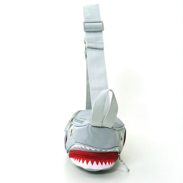 Novelty fanny pack shaped like a shark in grey nylon with large silver grommets for eyes. It has 6 exterior pockets for gills and zippered access to the interior through the shark’s mouth. Matching grey nylon adjustable strap. Shown flat from the front