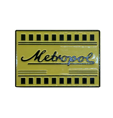 Bright yellow Metropol theatre ticket enamel pin