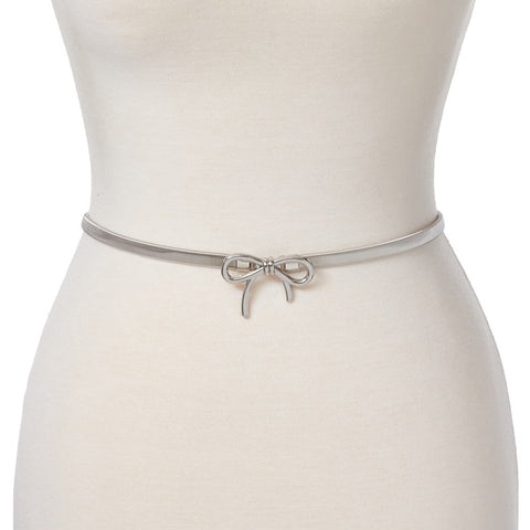Dress form wearing a silver metal serpentine style stretch belt with a matching metal bow buckle