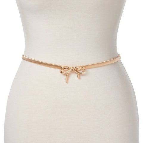 Dress form wearing a gold metal serpentine style stretch belt with a matching metal bow buckle
