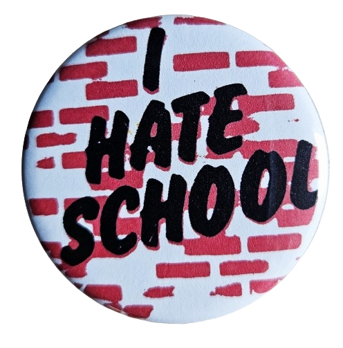 1.25” round button with white background and red brick illustration with “I HATE SCHOOL” written in black italics across