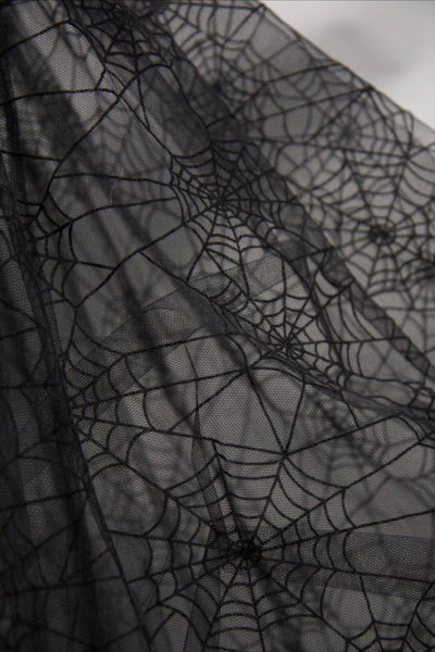 close up fabric swatch of sheer black mesh with flocked black spiderweb pattern