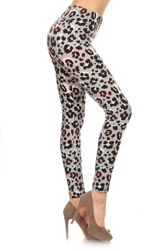 High-waist leggings in a black, white, grey, bright blue, and coral leopard print. Shown on a model from a side angle