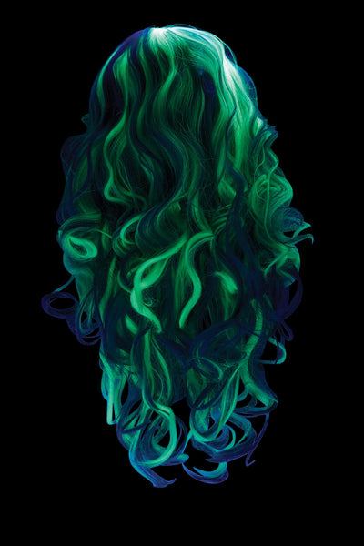 A woman wearing a long, wavy platinum white wig glowing in the dark shown charged and glowing shown from the back