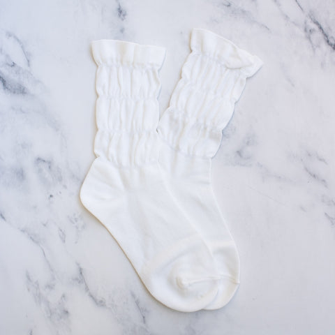 ivory white knit socks with ruffled hem and three rows of elasticized gathering down the ankle