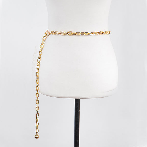 Gold metal link style chain belt with silver round charm at the end shown on dress form