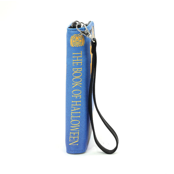textured bright blue faux leather with black and yellow print book-shaped "The Book of Halloween" wallet. Shown from side with "spine"