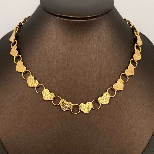 16" necklace made of linked hammered texture gold hearts connected with large gold jump rings. Shown on dress form