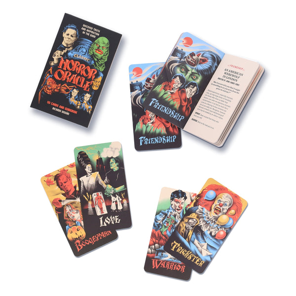 Set of colorful oracle cards with horror-themed illustrations and open guidebook on a white background