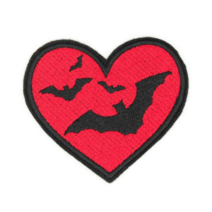 red heart embroidered patch with black outline and four flying black bats inside