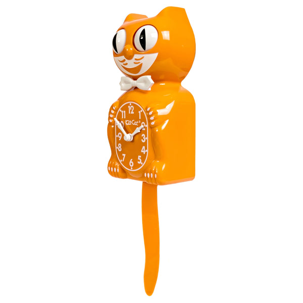 Medium orange colored cat clock with white features and white bow tie. Shown from three quarter angle