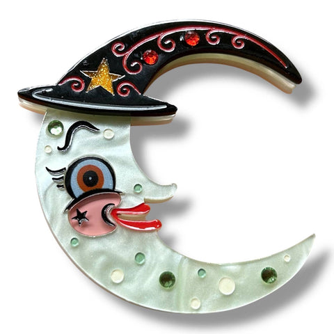 layered acrylic crescent moon brooch with face and black witch hat decorated with red rhinestones and glittery yellow stars