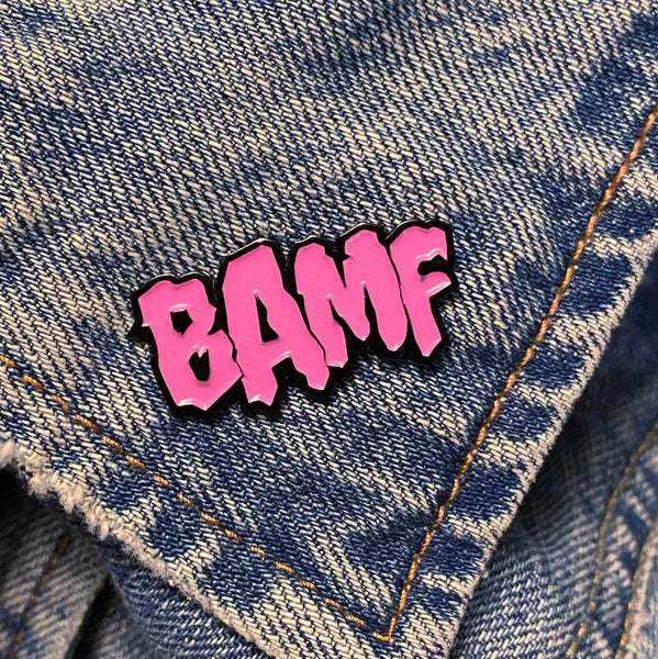 comic sfx onomatopoeia enamel pin "BAMF" in pink on denim background