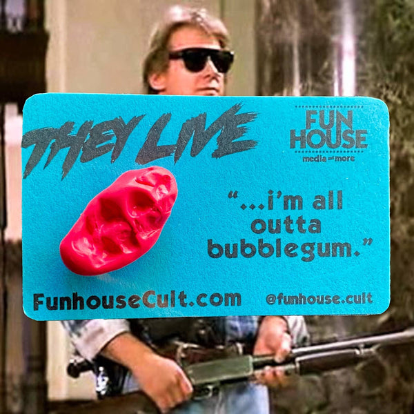 neon pink polymer clay pin in the shape of a chewed wad of gum on blue backing card with 'They Live' logo and "I'm all out of bubblegum" quote