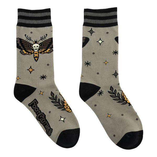 pair of unisex cotton blend greenish beige background crew socks with pattern of brown and yellow death's head moth and caterpillar alongside tiny black and yellow stars. Shown flat