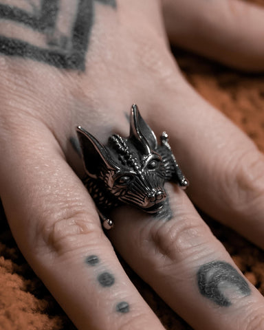 Model wearing a stainless steel ring in the shape of a highly detailed bat’s head and wings. Shown from the front