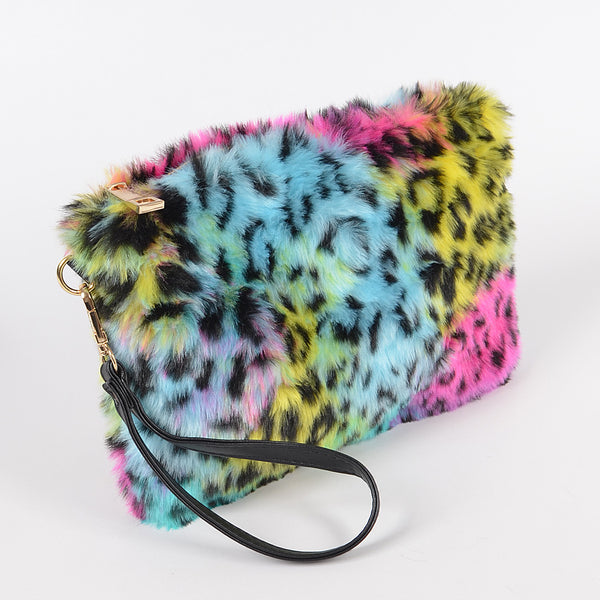 rainbow leopard print faux fur fanny pack purse with top zipper closure, gold curb chain shoulder strap, and black faux leather hand strap. Shown from side with hand strap only