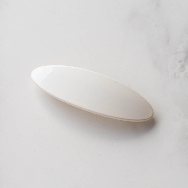 creamy white oval shaped acrylic barrette. Shown from front