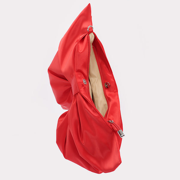 red satin oversized bow-shaped purse with matching crossbody strap. Shown open from top