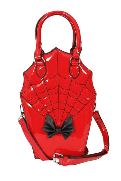 Cherry red patent vinyl handbag in the shape of a scalloped coffin with a black bow detail, hand strap, and black spiderweb patterned stitching. Shown from front with strap attatched