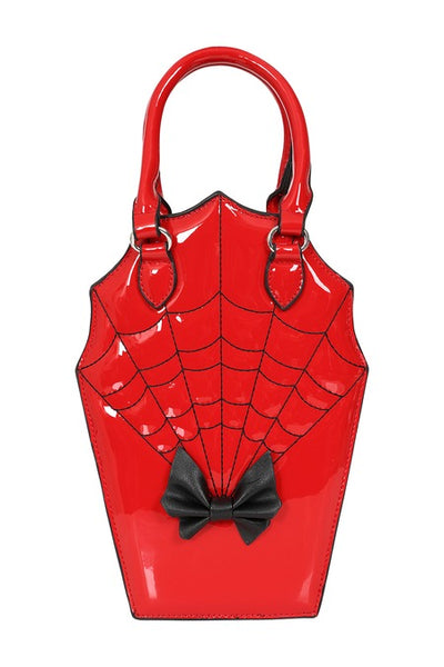 Cherry red patent vinyl handbag in the shape of a scalloped coffin with a black bow detail, hand strap, and black spiderweb patterned stitching. Shown from front