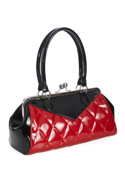 Vintage-inspired handbag made of black and red vinyl with red quilted body and black sides & top with matching black handles. Purse has silver metal kiss lock opening and matching detachable shoulder strap. Shown from side