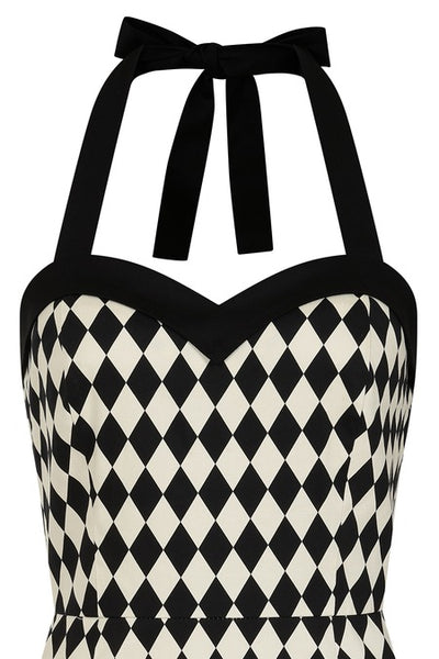 Halter style wiggle dress in black and white harlequin printed cotton sateen with sweetheart neckline, contrasting black black trim at the bodice with black halter straps and princess seaming with pencil length skirt. Shown from front In close up of bodice