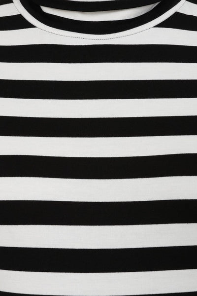 black and bright white jersey knit sleeveless mock neck pencil dress shown from front in close up
